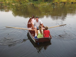 Flat Skiff 12 with four people aboard